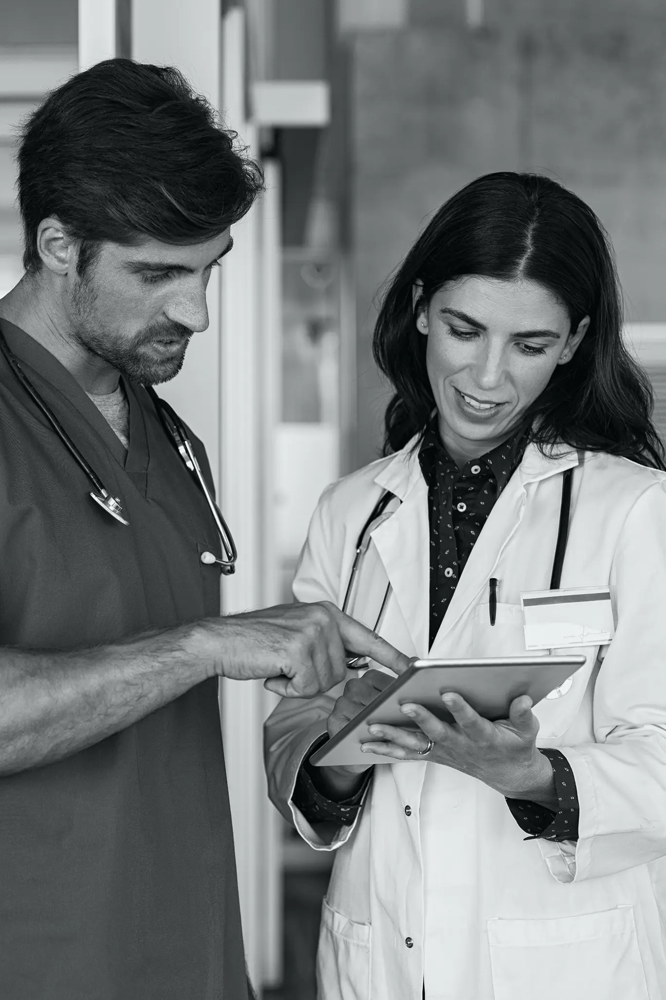 Doctor and Nurse Looking at Tablet