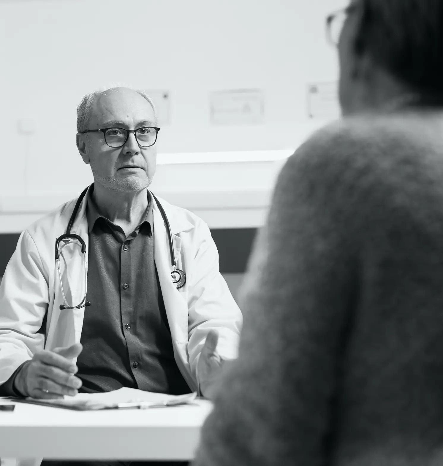 senior doctor consulting a patient