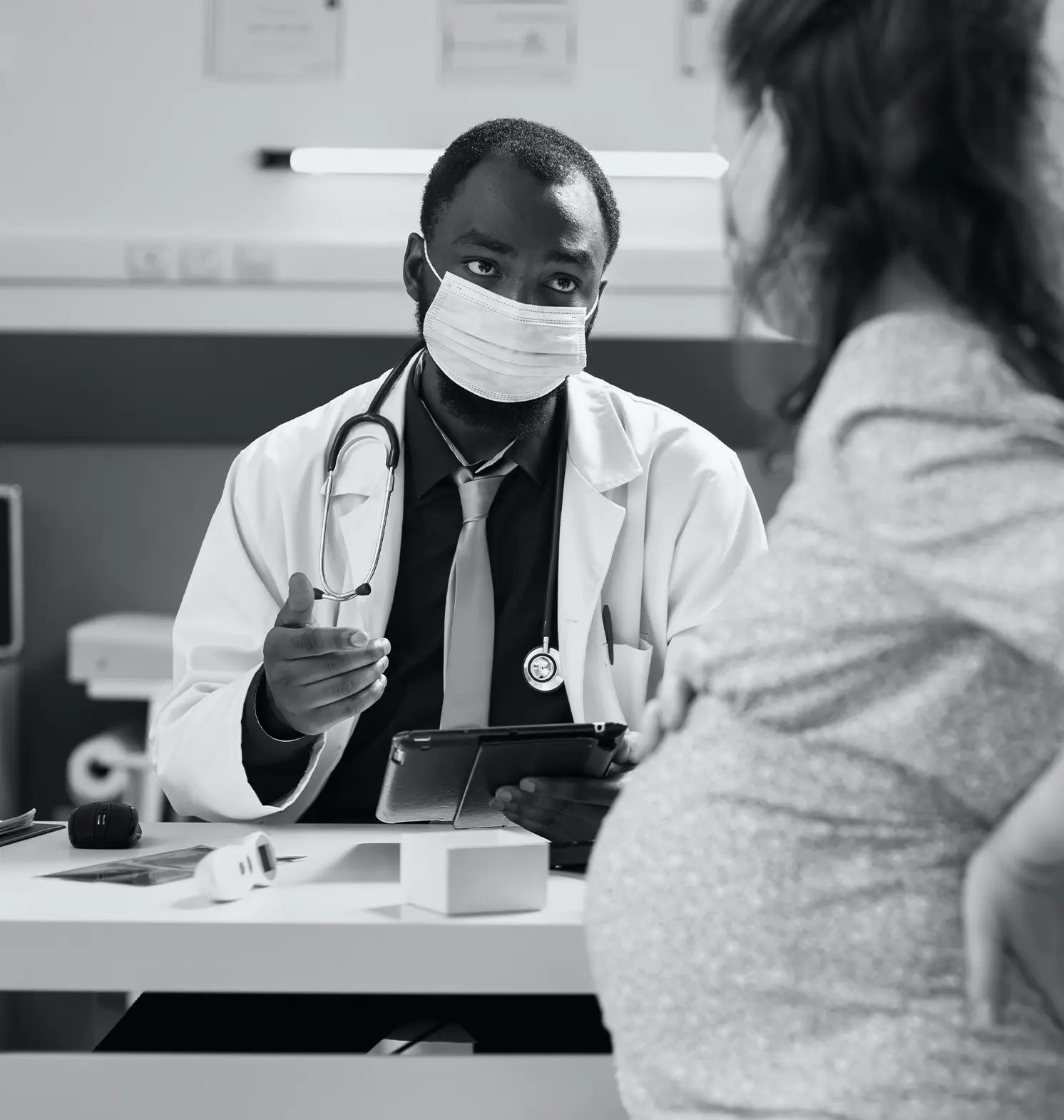 obstetrician consulting a pregnant patient