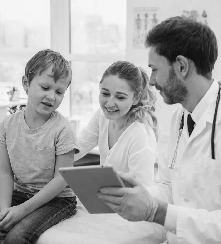 A pediatrician showing reports to patient family